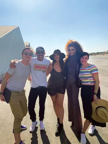 Kathryne Hall ’99 (right) poses with Zendaya (second from right) and three others on a sunny day near an airstrip, all smiling and dressed in stylish, casual outfits. Kathryne Hall ’99 (right) poses with Zendaya (second from right) and three others on a sunny day near an airstrip, all smiling and dressed in stylish, casual outfits.