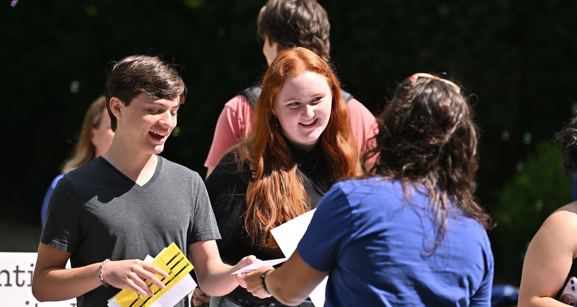 Two students at The College of Wooster collect information at APEX's outdoor information fair Two students at The College of Wooster collect information at APEX's outdoor information fair